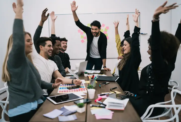 Team celebrating success in office